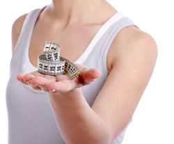 Young woman holding a tape measure